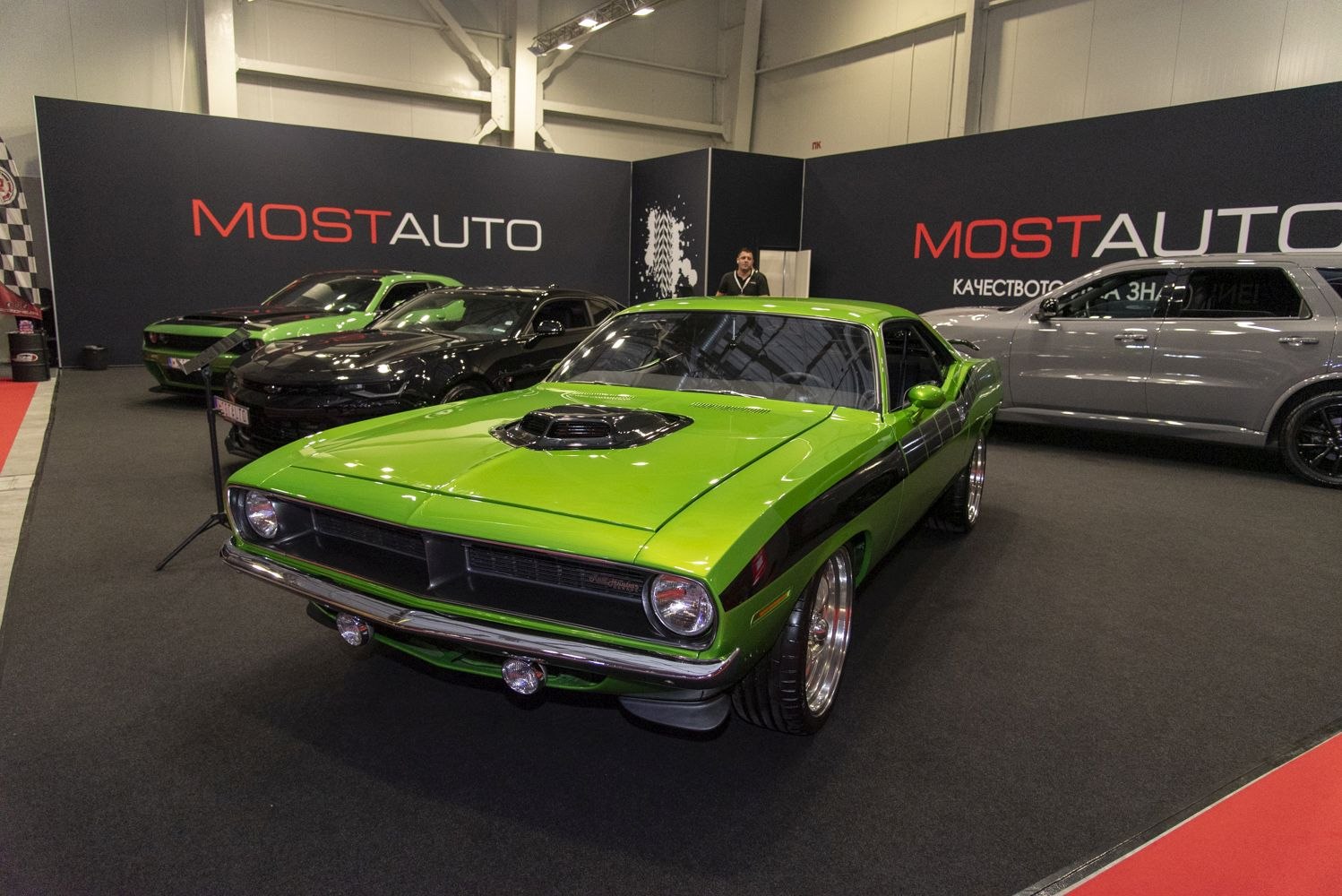 Green vintage muscle car with hood scoop and black side stripe