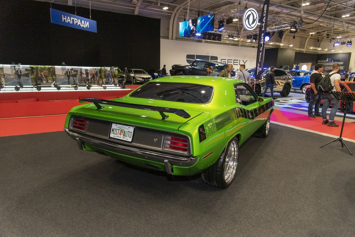 Rear view of classic muscle car with black rear spoiler and Cuda stripe