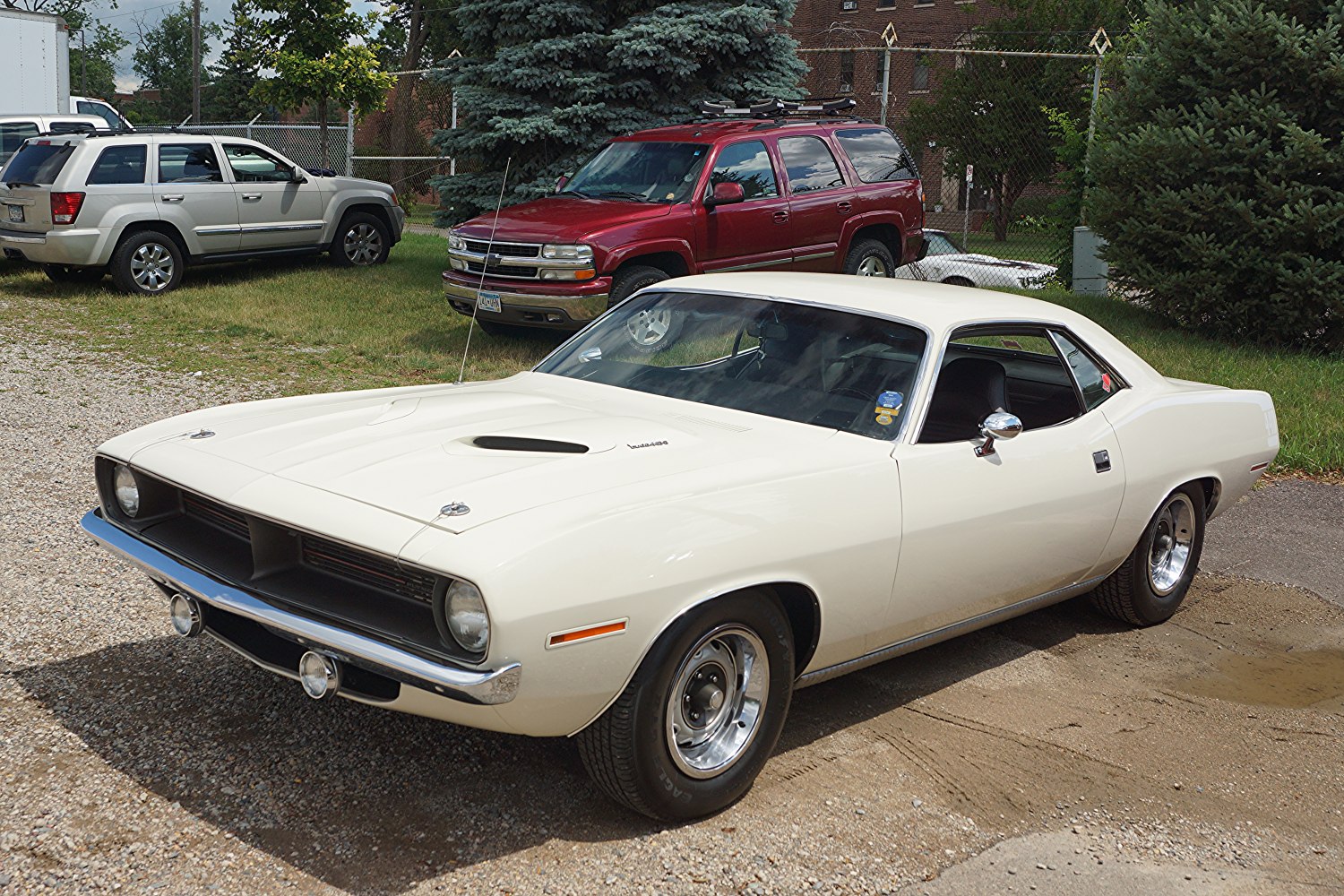 White muscle coupe with hood scoop and chrome bumpers