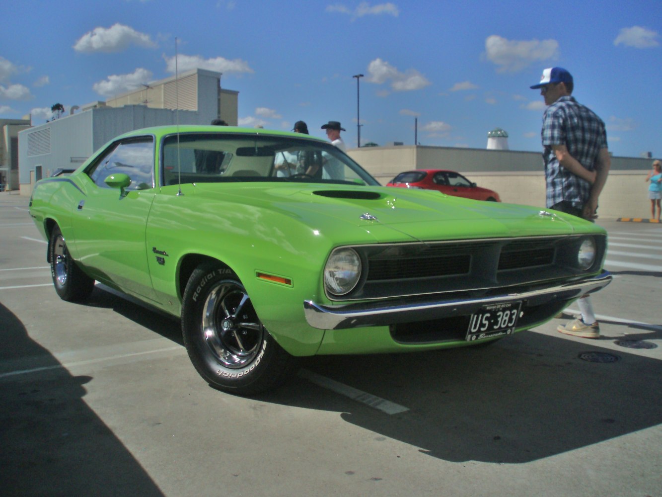 Front view of a classic muscle car with grille and hood scoop