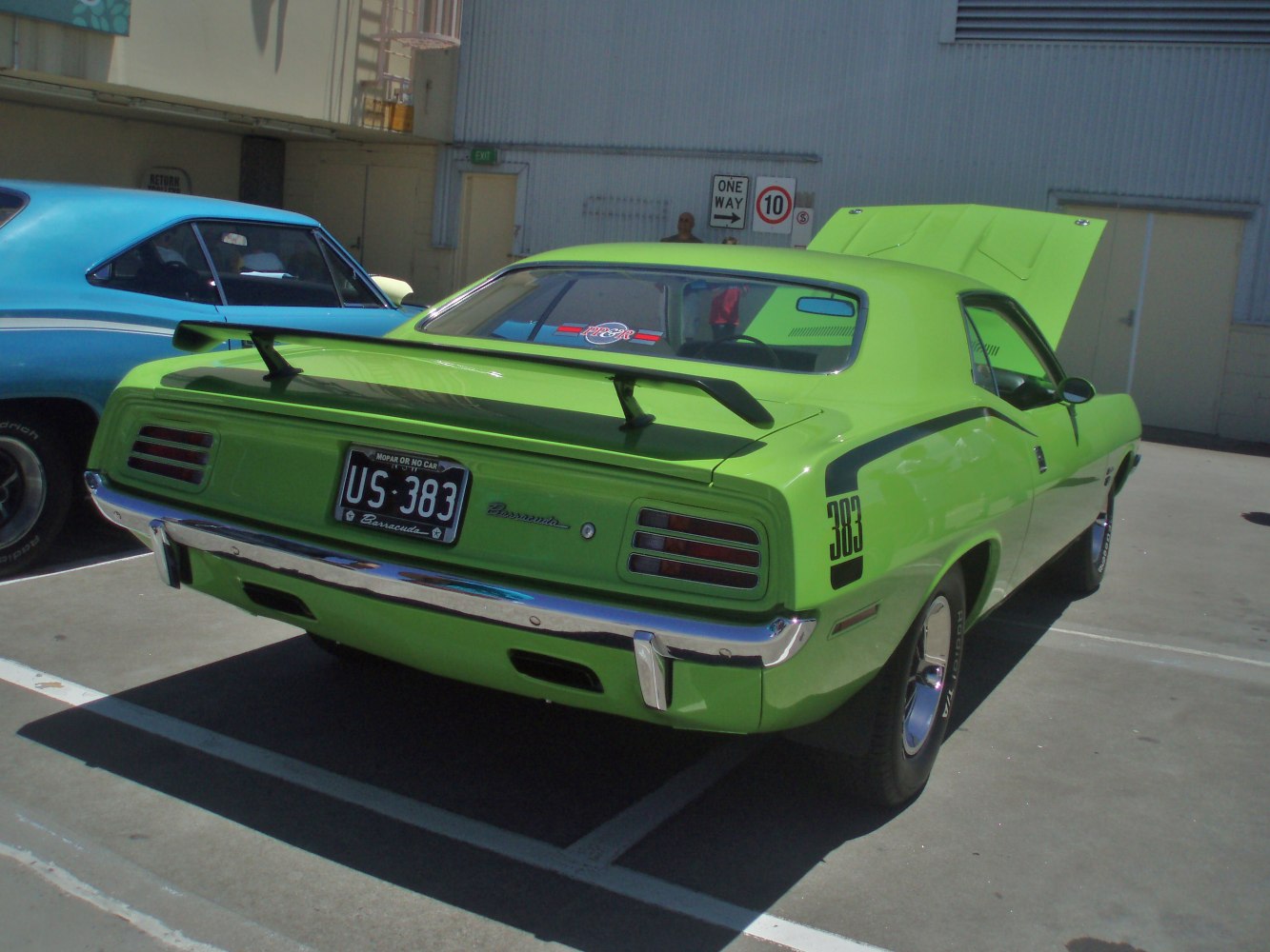Rear view of green muscle car with spoiler and 383 decal