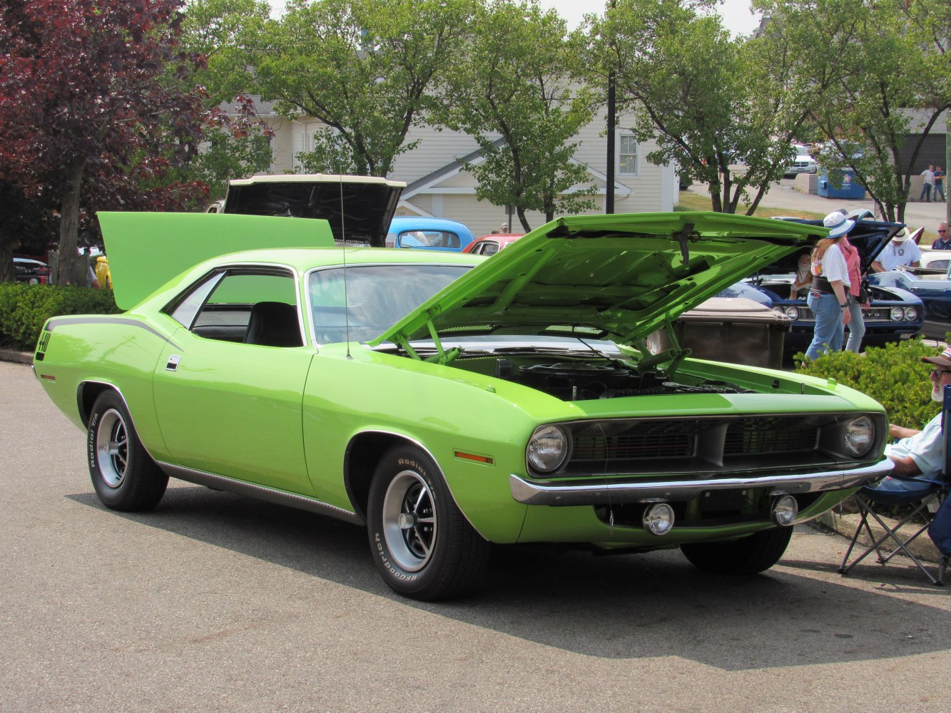 Green classic muscle car with raised hood
