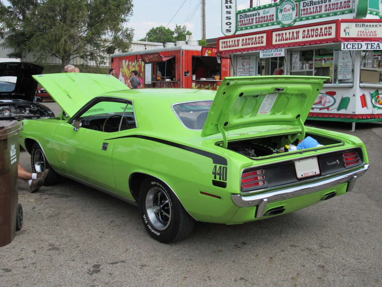 Lime green muscle car with open rear trunk and front hood, 440 badge on side.