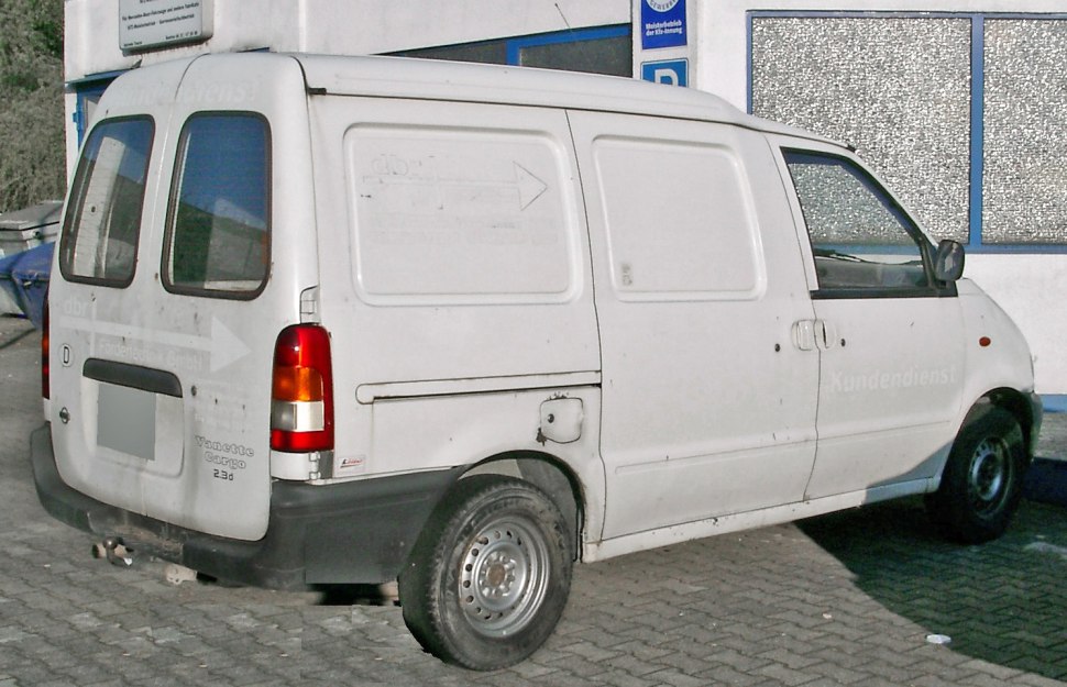 Rear and side view of white compact cargo van with steel wheels