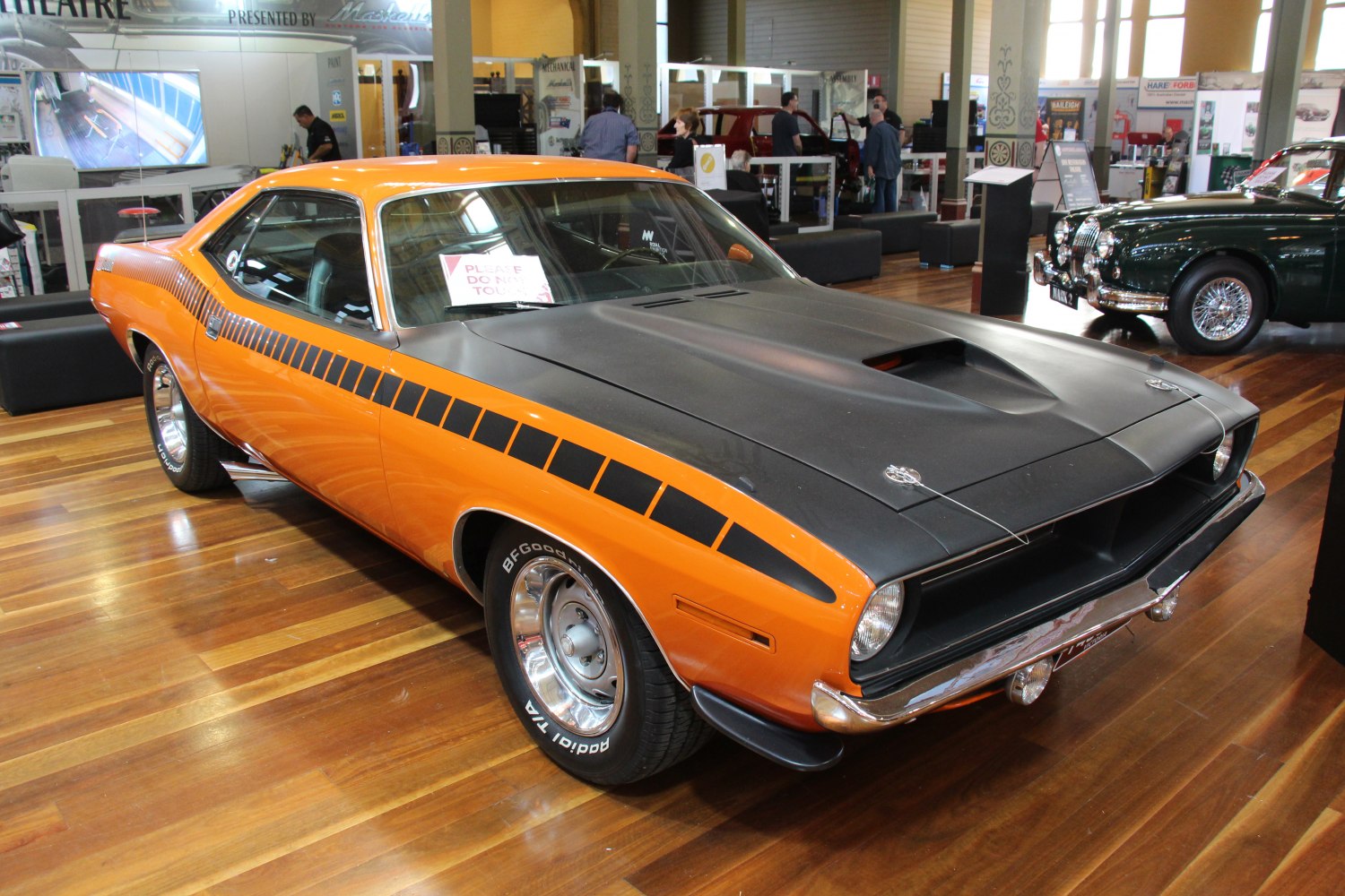 Muscle car with matte black hood scoop and bold side stripes