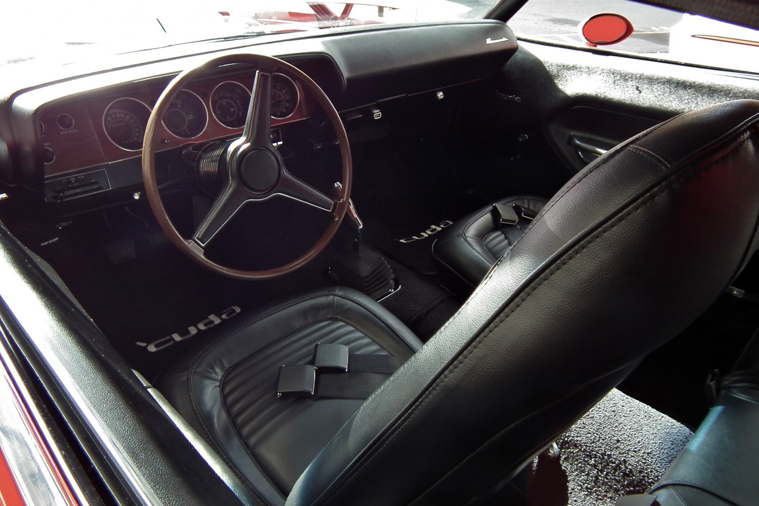 Vintage steering wheel and classic dashboard with black leather seats