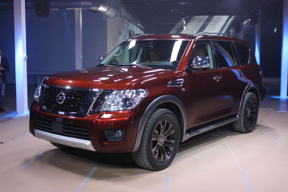 Front angled view of a red SUV with prominent grille and headlights.