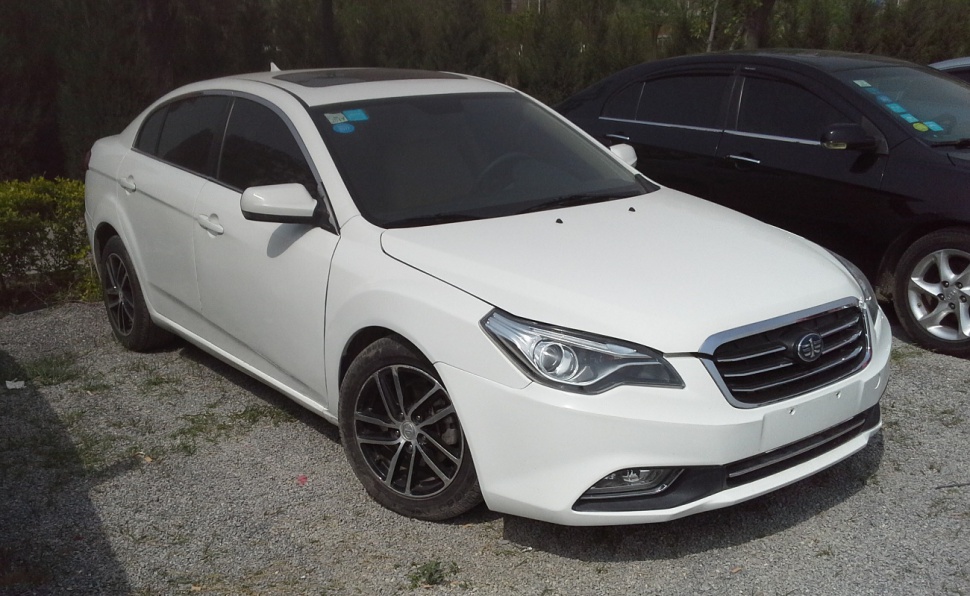 White sedan with sharp headlights and alloy wheels, shown from front-side angle.