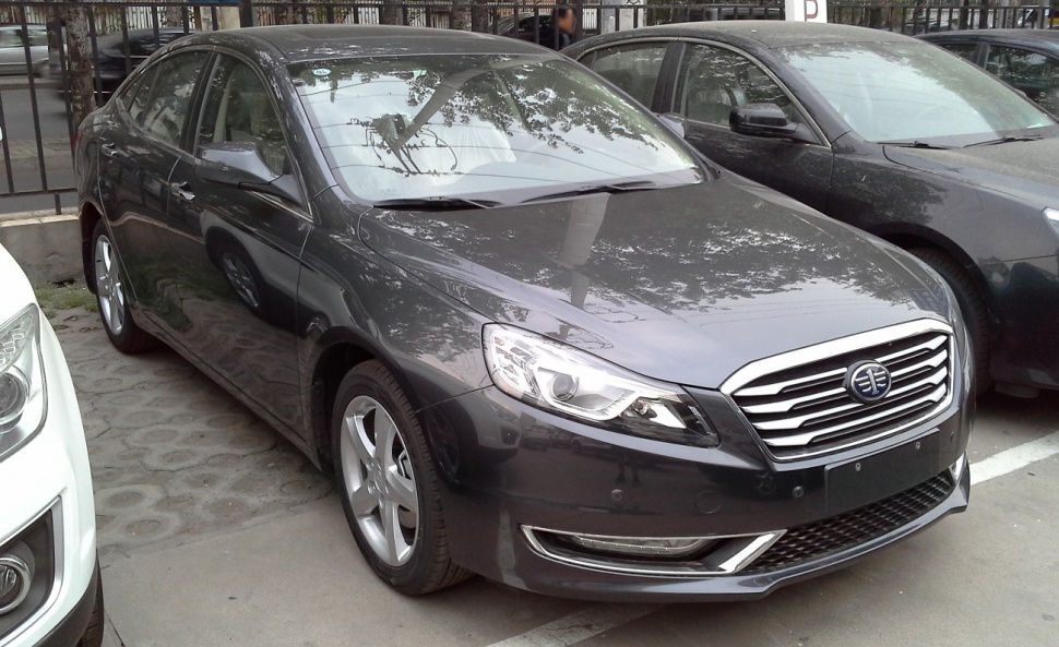 Front view of a sedan with chrome grille and modern headlights