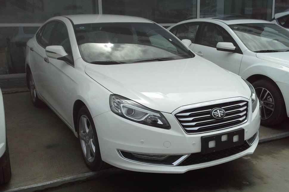 White sedan with chrome grille and LED headlights front angled view