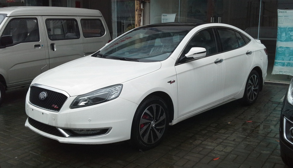 White sedan with sharp headlights and sporty alloy wheels
