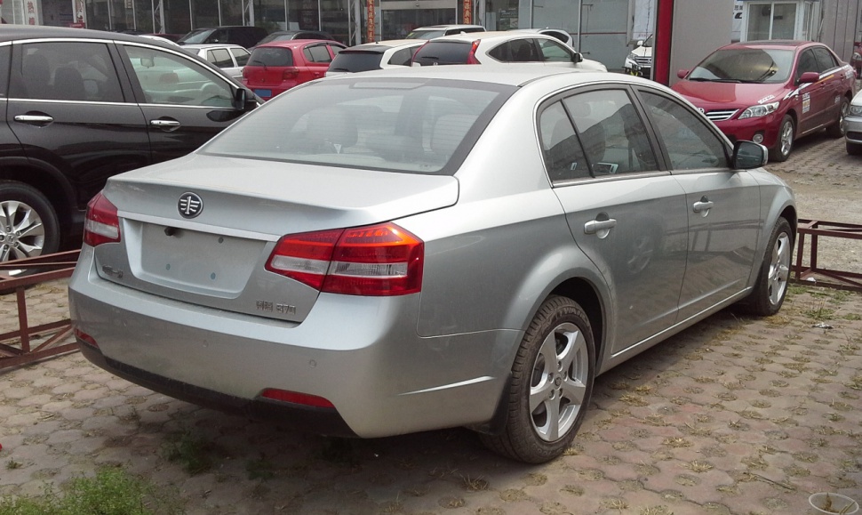 Silver sedan rear view with distinct taillights and alloy wheels