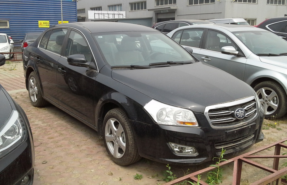 Black mid-size sedan with chrome grille and sleek headlamp design