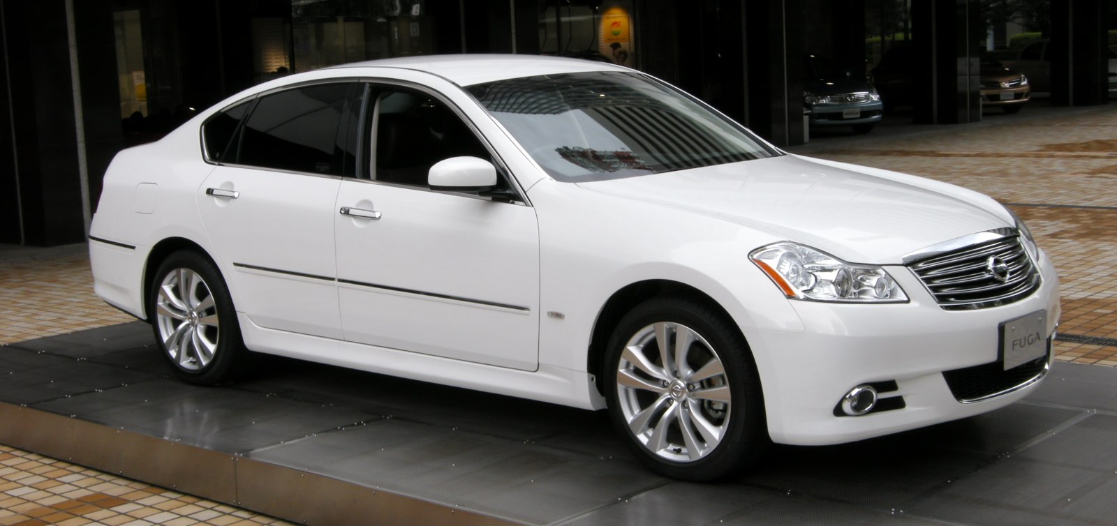 White luxury sedan with sleek body and alloy wheels from front-side view