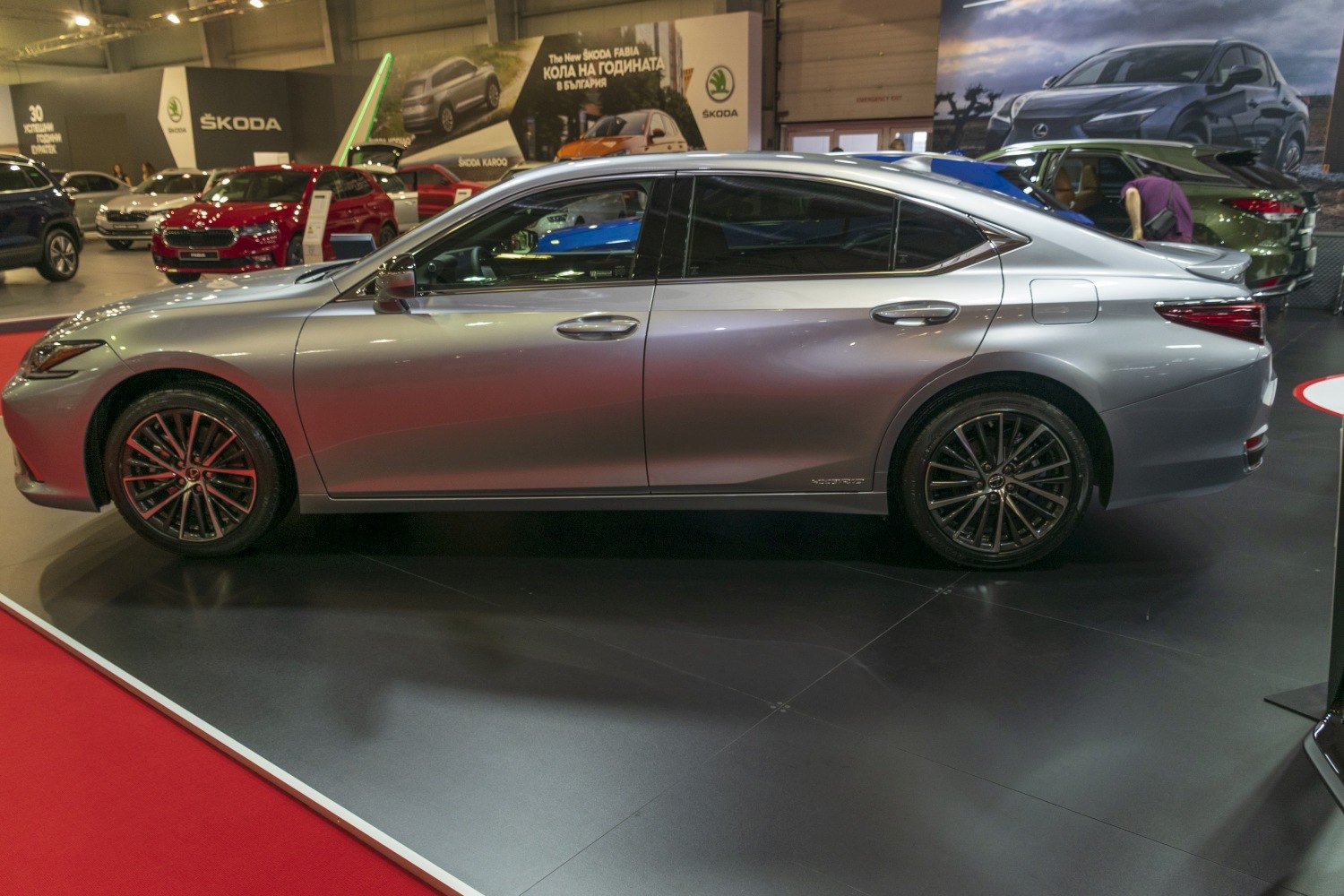 Silver luxury sedan side profile with alloy wheels and tinted windows