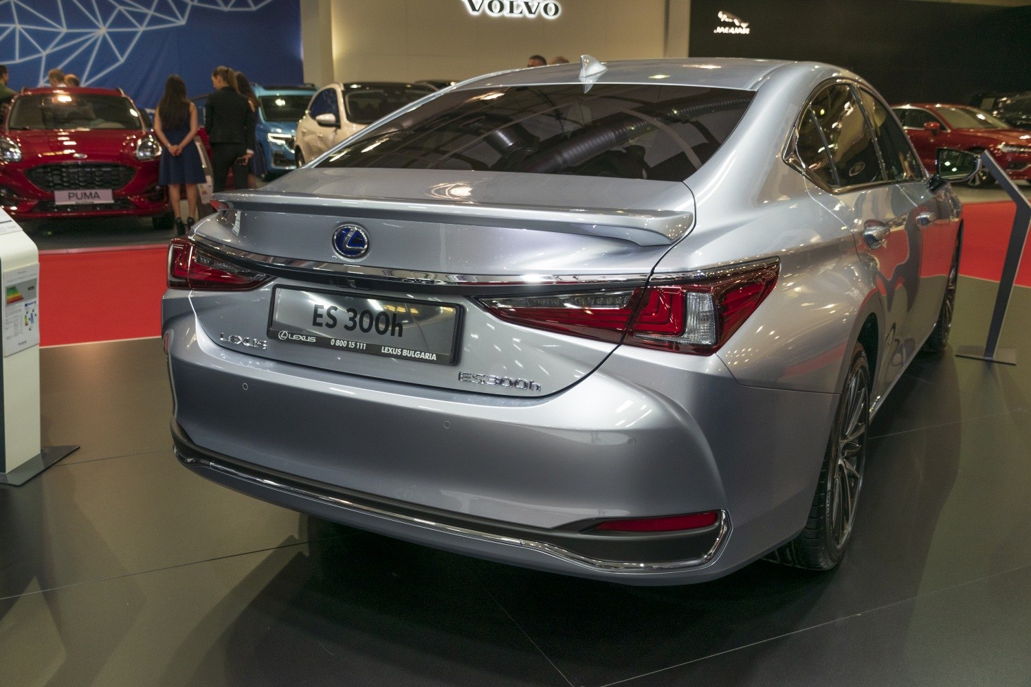 Rear view of silver luxury sedan with integrated spoiler and modern LED taillights