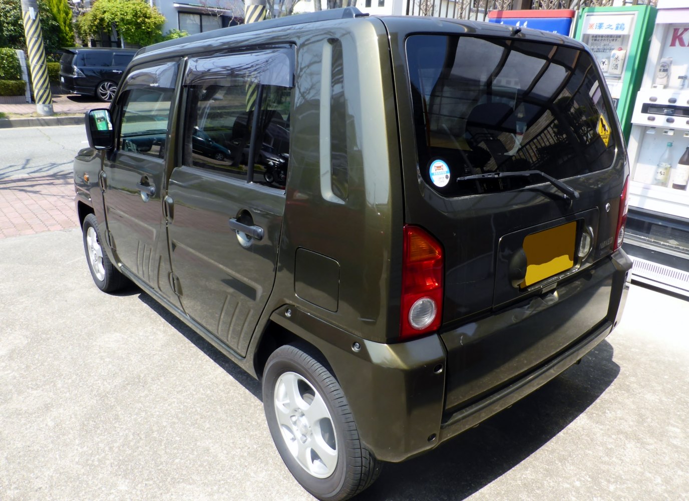 Boxy compact hatchback rear with tinted glass and vertical tail lights