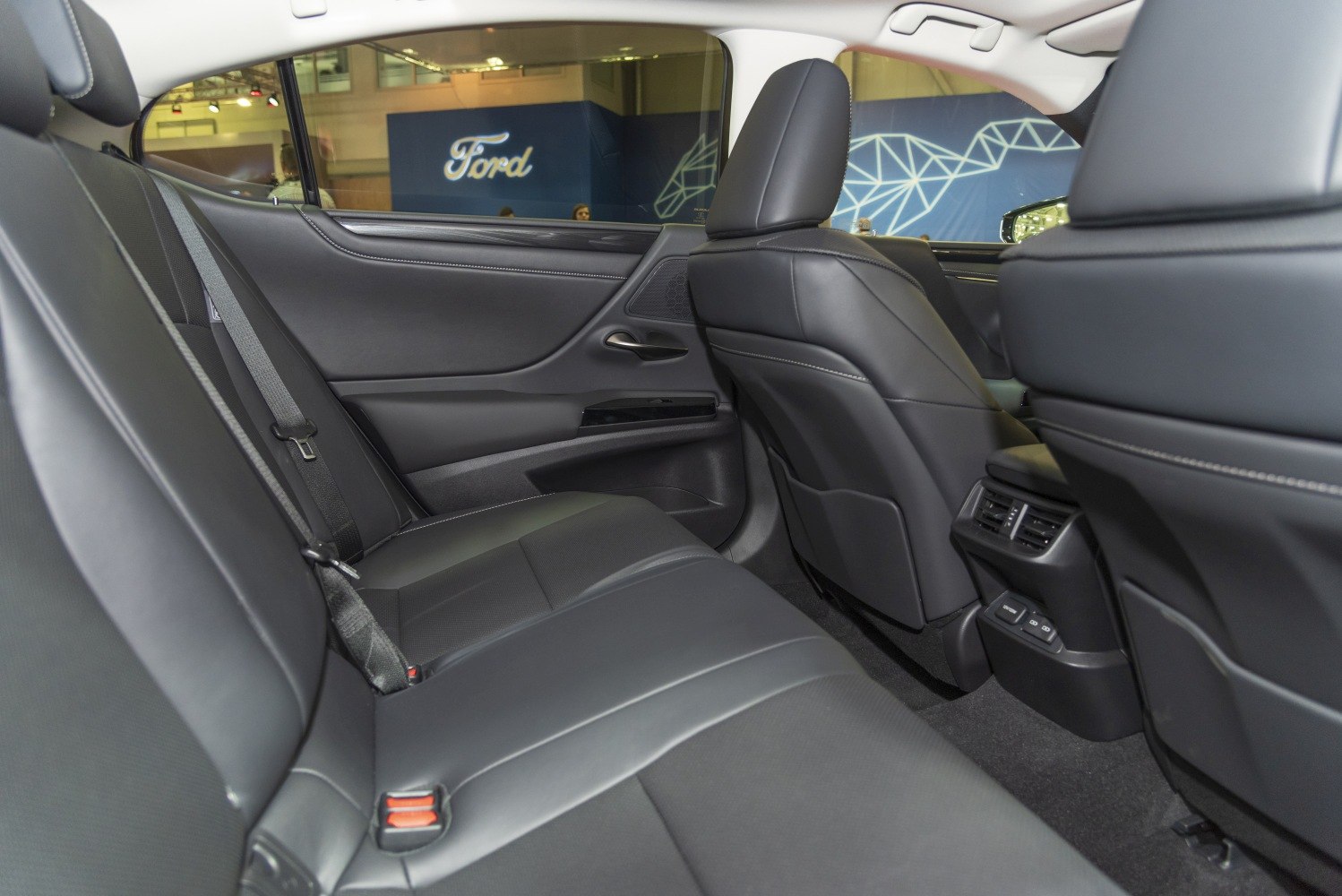 Rear seat interior with black leather upholstery and rear climate control vents