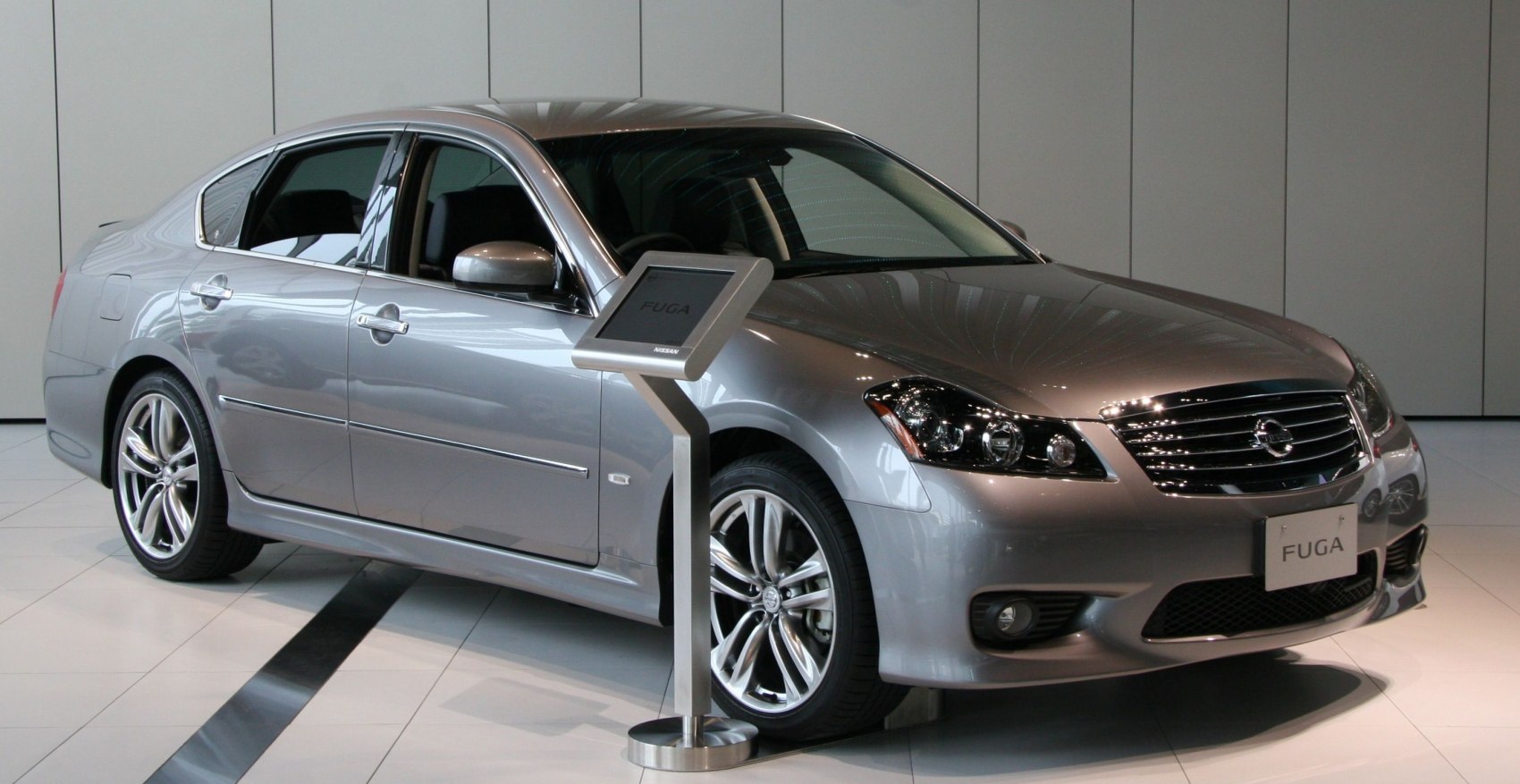 Silver luxury sedan with alloy wheels and chrome grille
