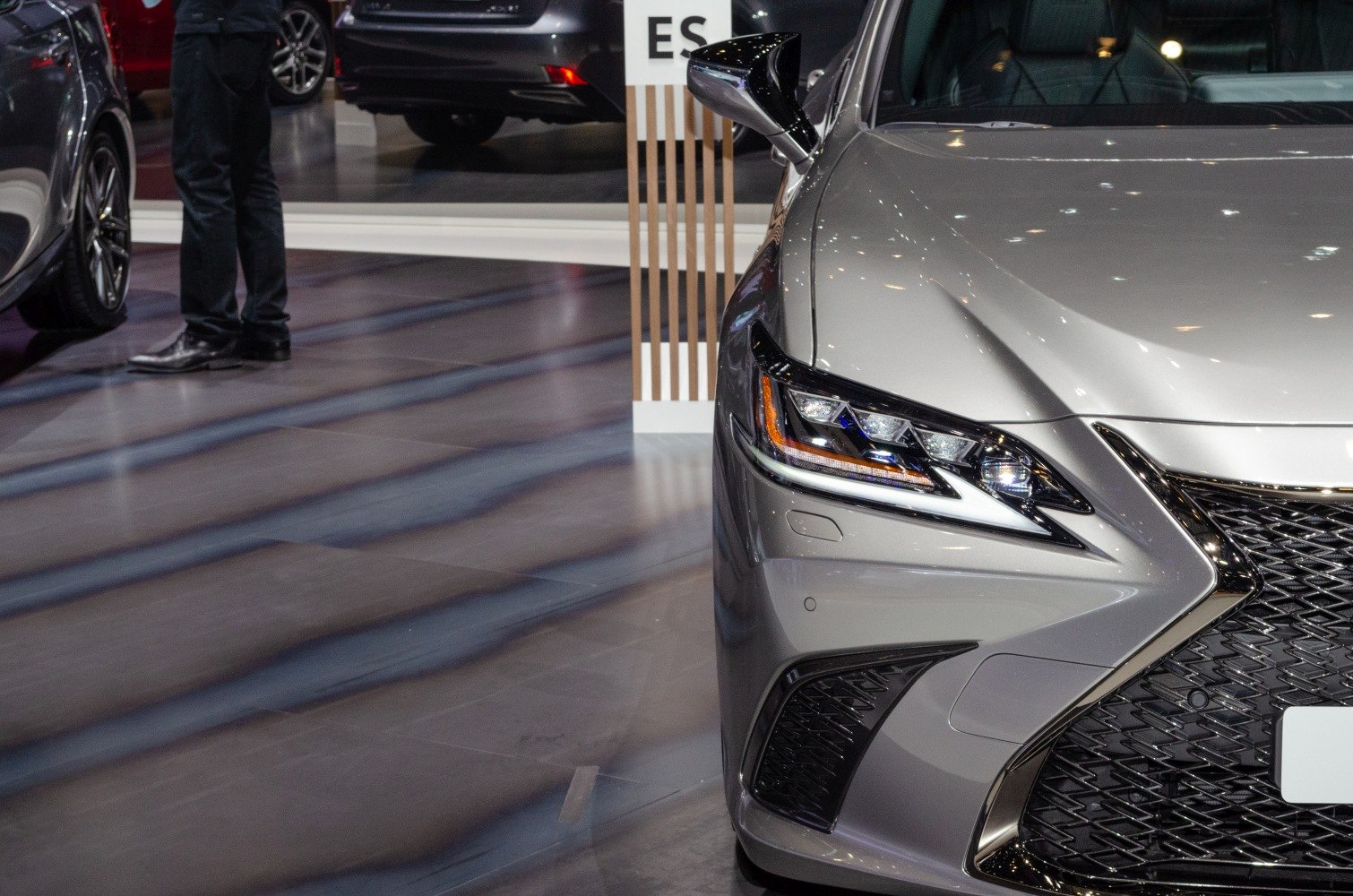 Close-up of front headlight and grille with sharp design lines