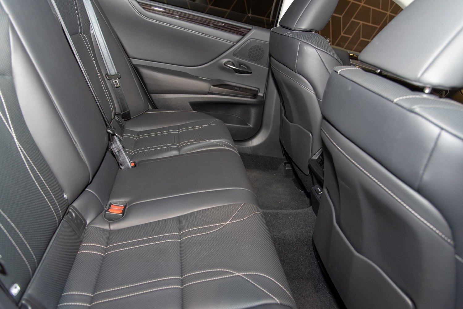 Black leather rear seats with detailed stitching and spacious legroom