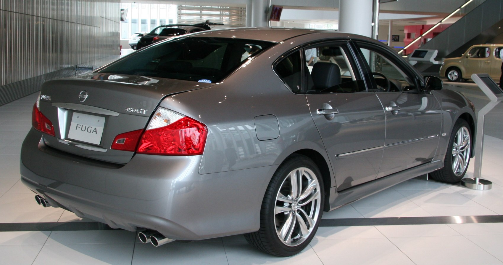 Rear side view with dual exhaust pipes and alloy wheels