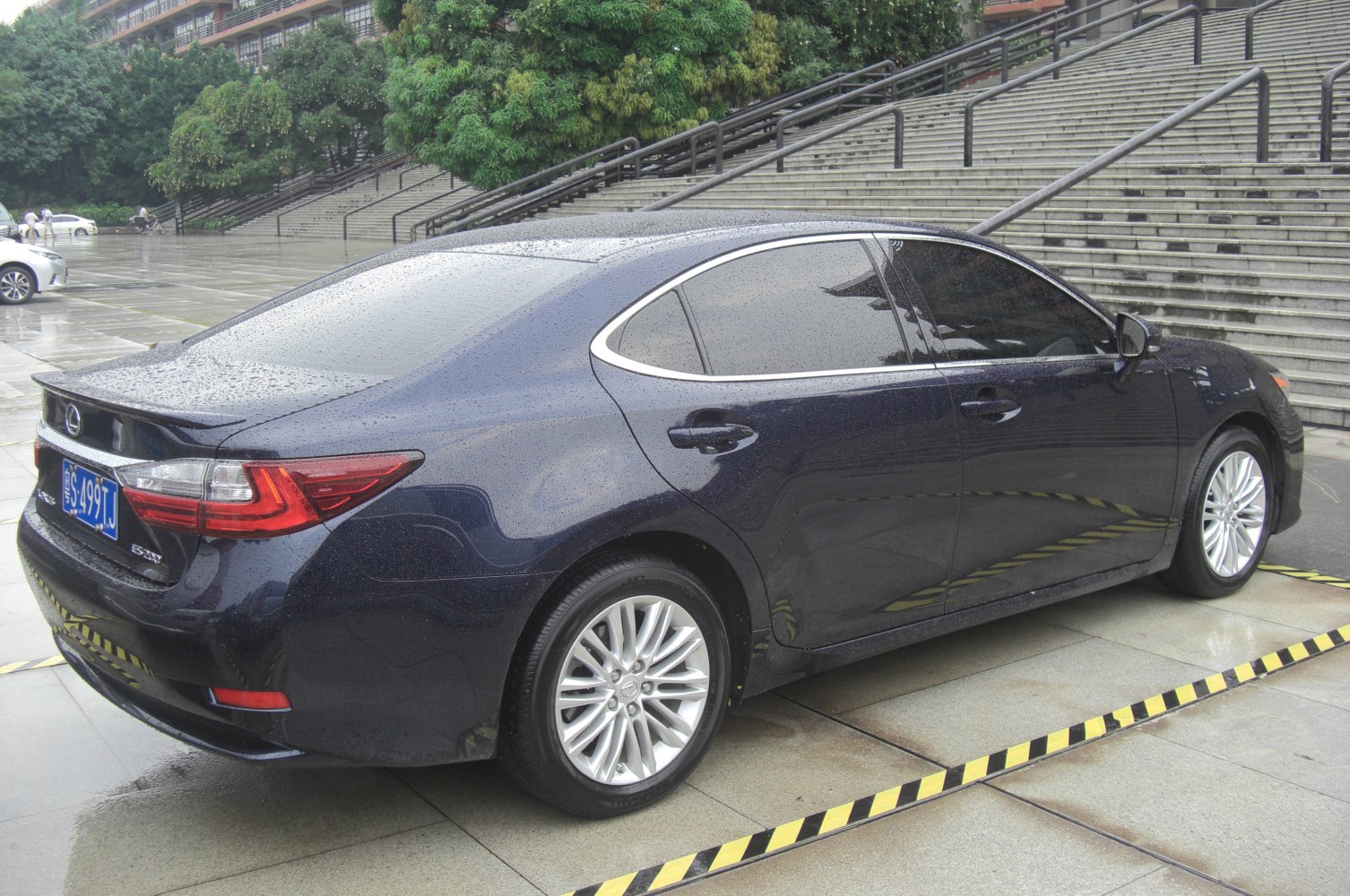 Rear side view of luxury sedan with modern taillights and alloy wheels