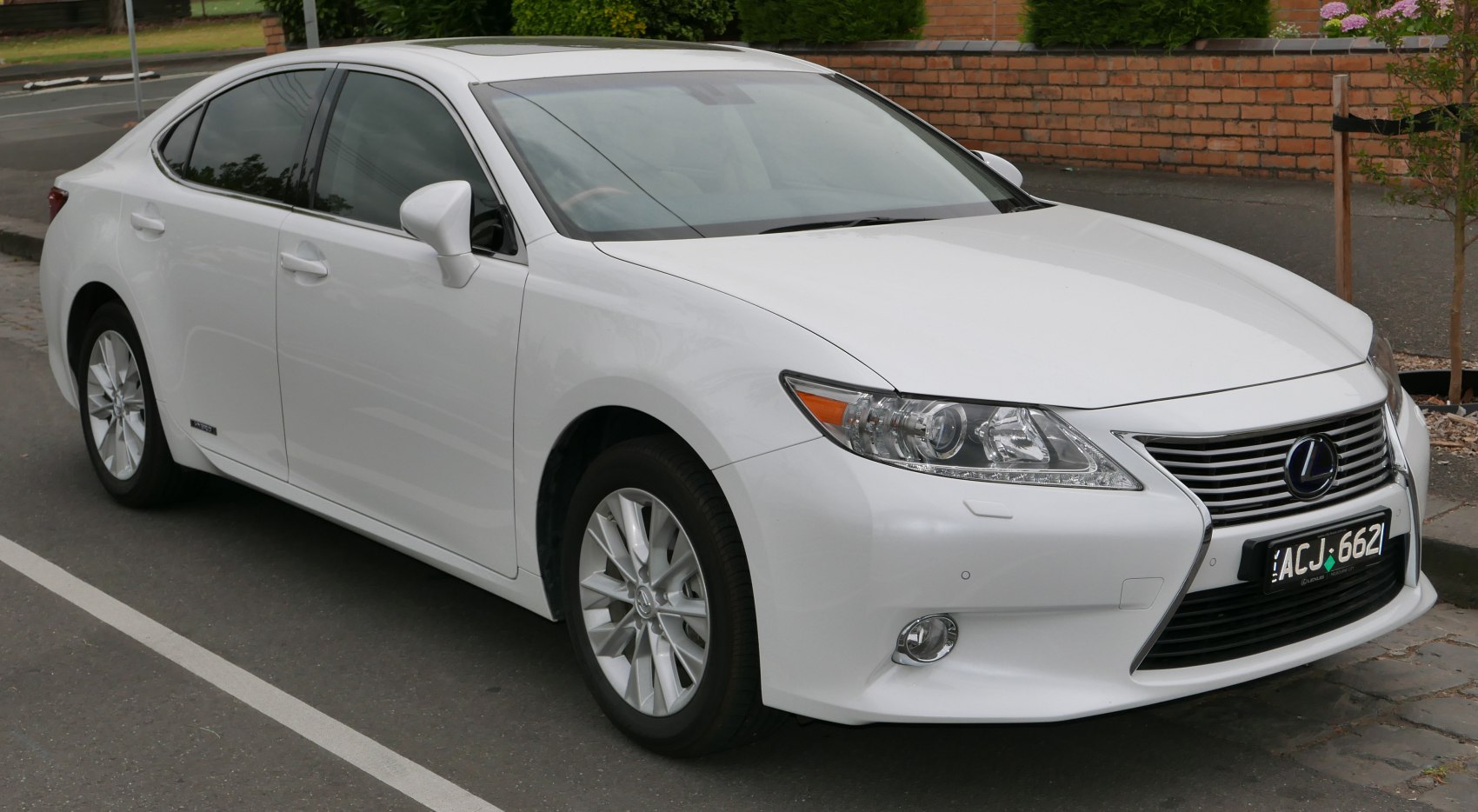 Front and side view of white sedan with signature grille and alloy wheels.