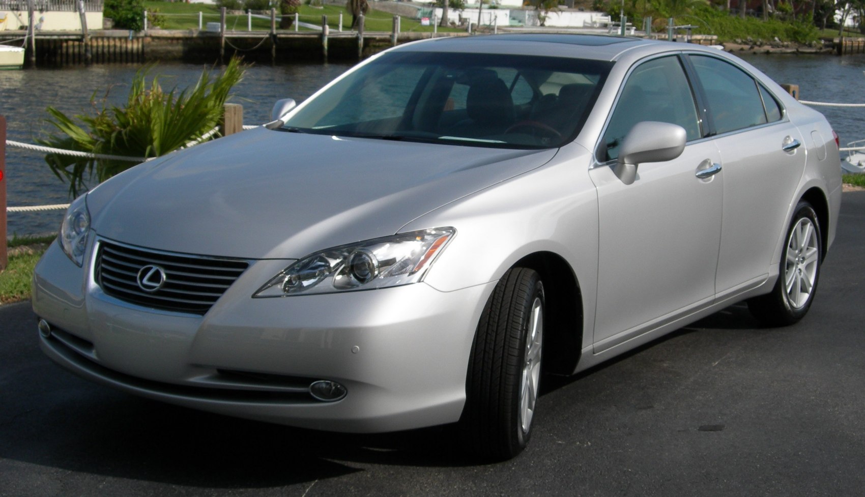 Silver luxury sedan with sleek headlights and chrome grille front view