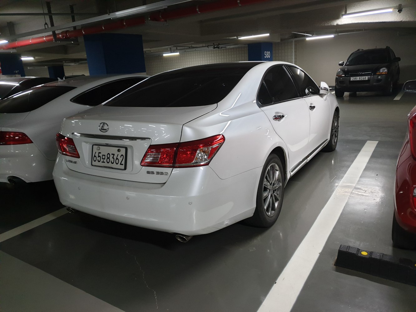 White luxury sedan with dual exhaust and LED taillights