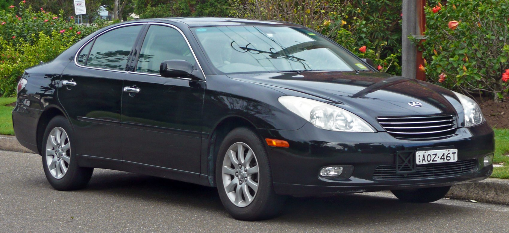 Front side view of a black sedan with alloy wheels
