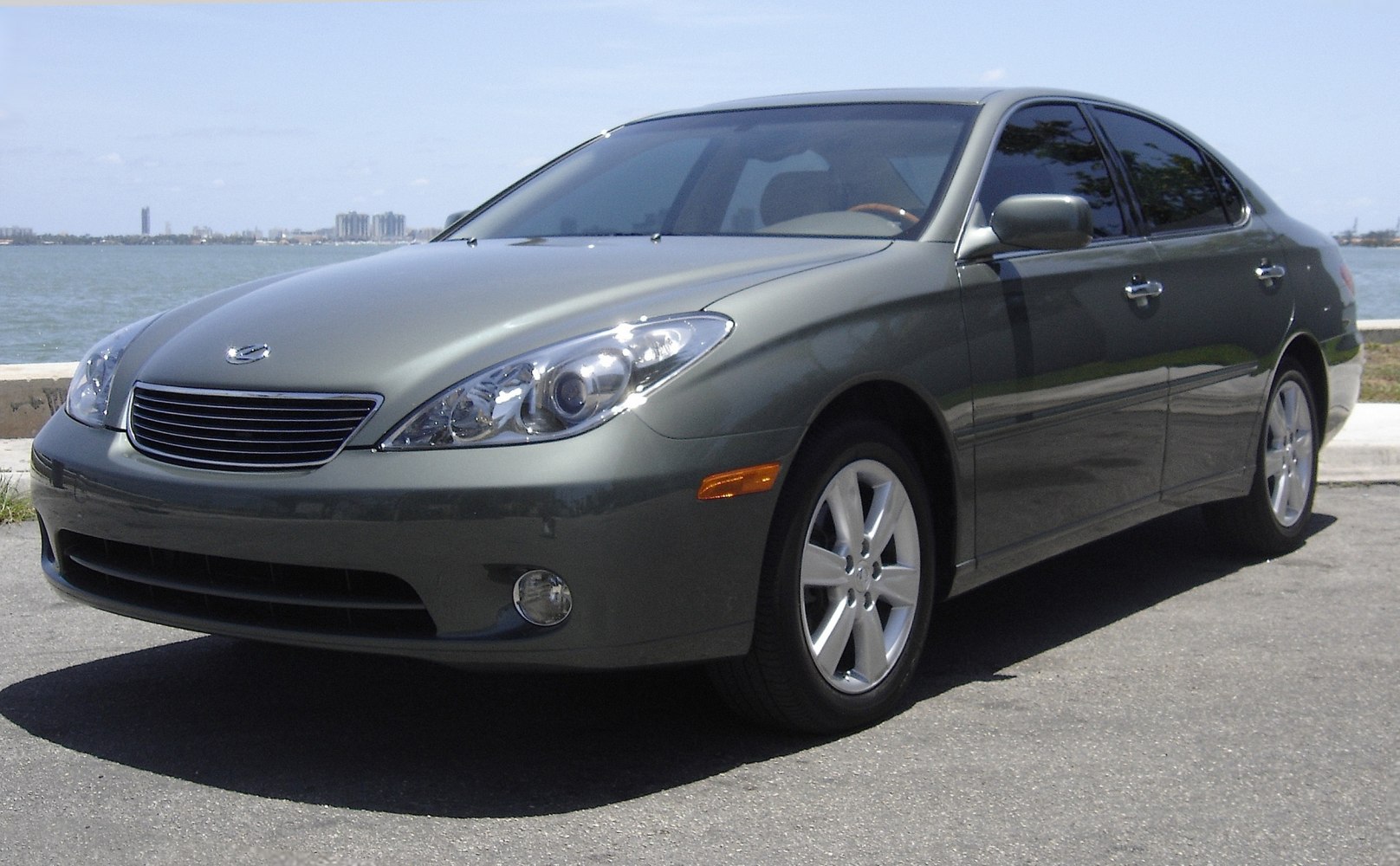 Front 3/4 view of a mid-size sedan with sleek headlights and smooth body lines