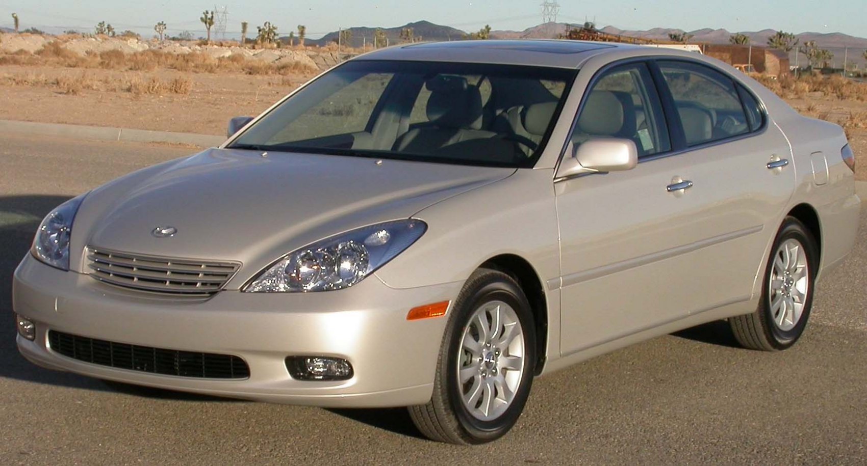 Front-side view of a sedan with projector headlights and alloy wheels