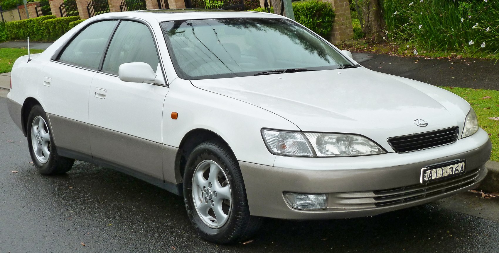 Front-side view of a white sedan with two-tone paint and alloy wheels