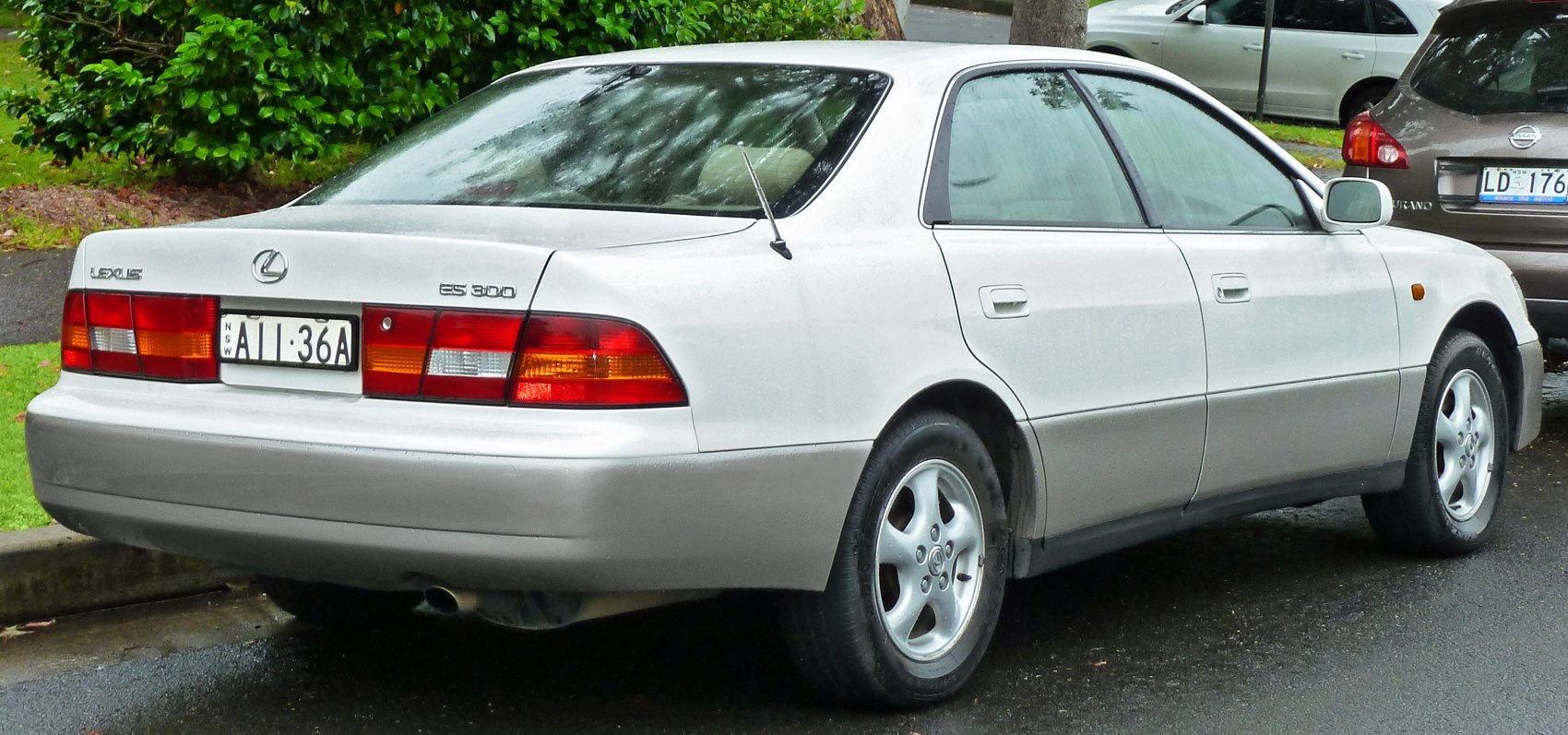 Silver sedan rear and side view with alloy wheels and classic taillights