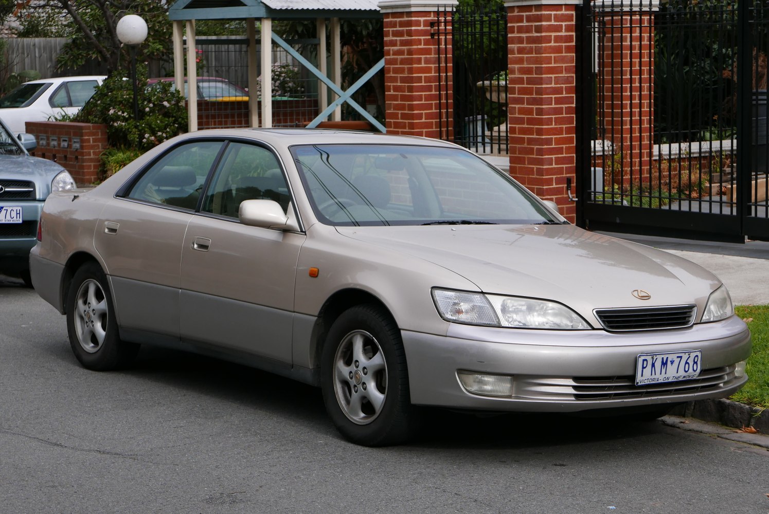 Front side exterior view of a mid-90s sedan with alloy wheels and clear headlights