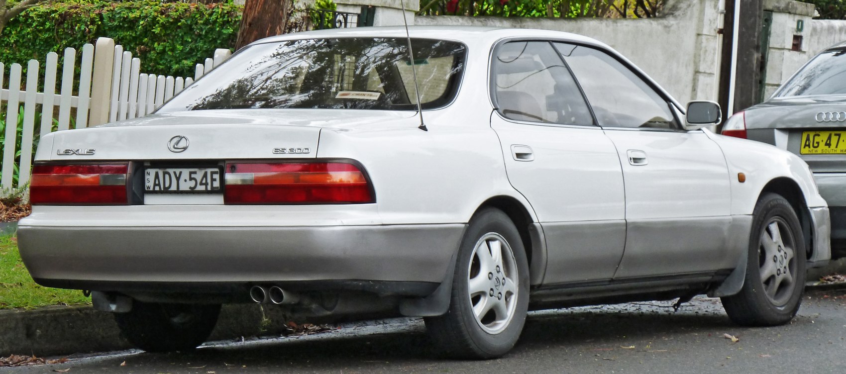 Rear view of a 1992 sedan with dual exhaust and classic tail lights