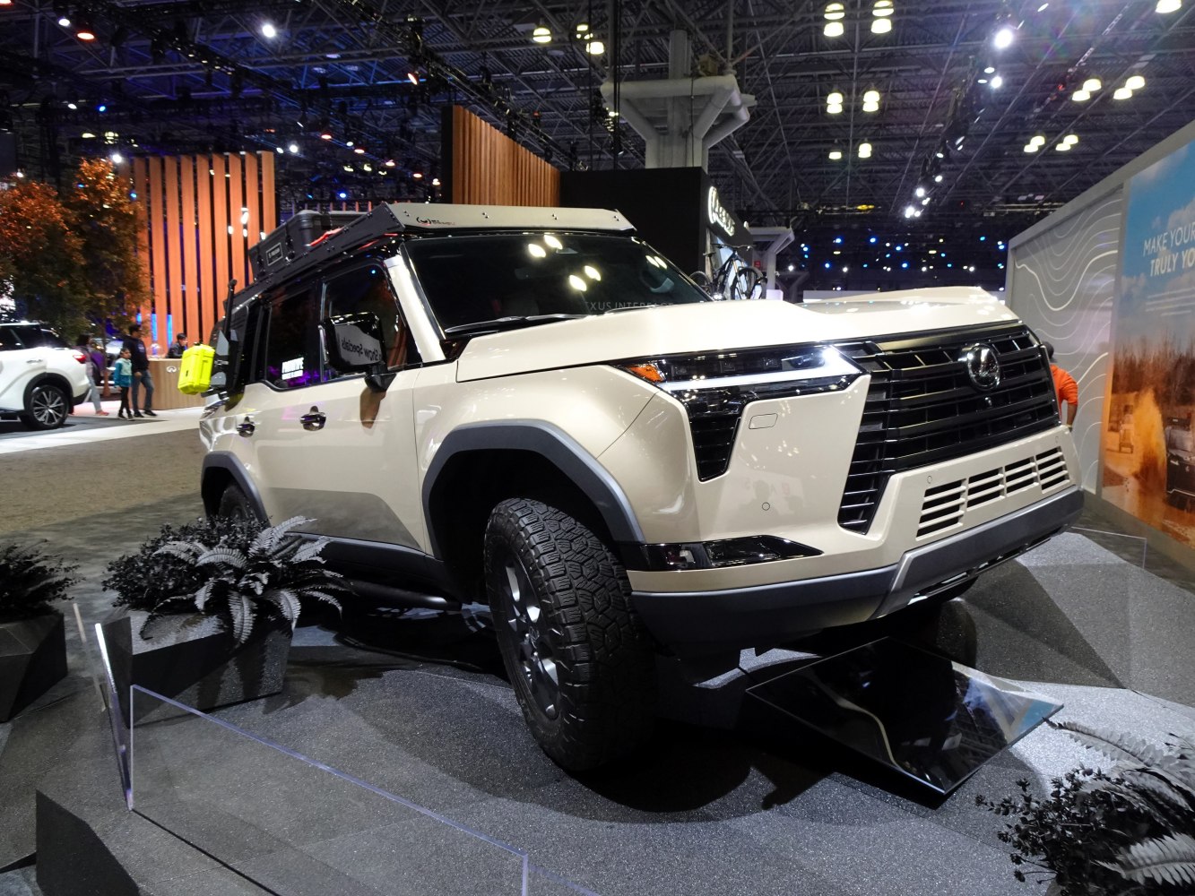 Front view with aggressive off-road tires and roof rack
