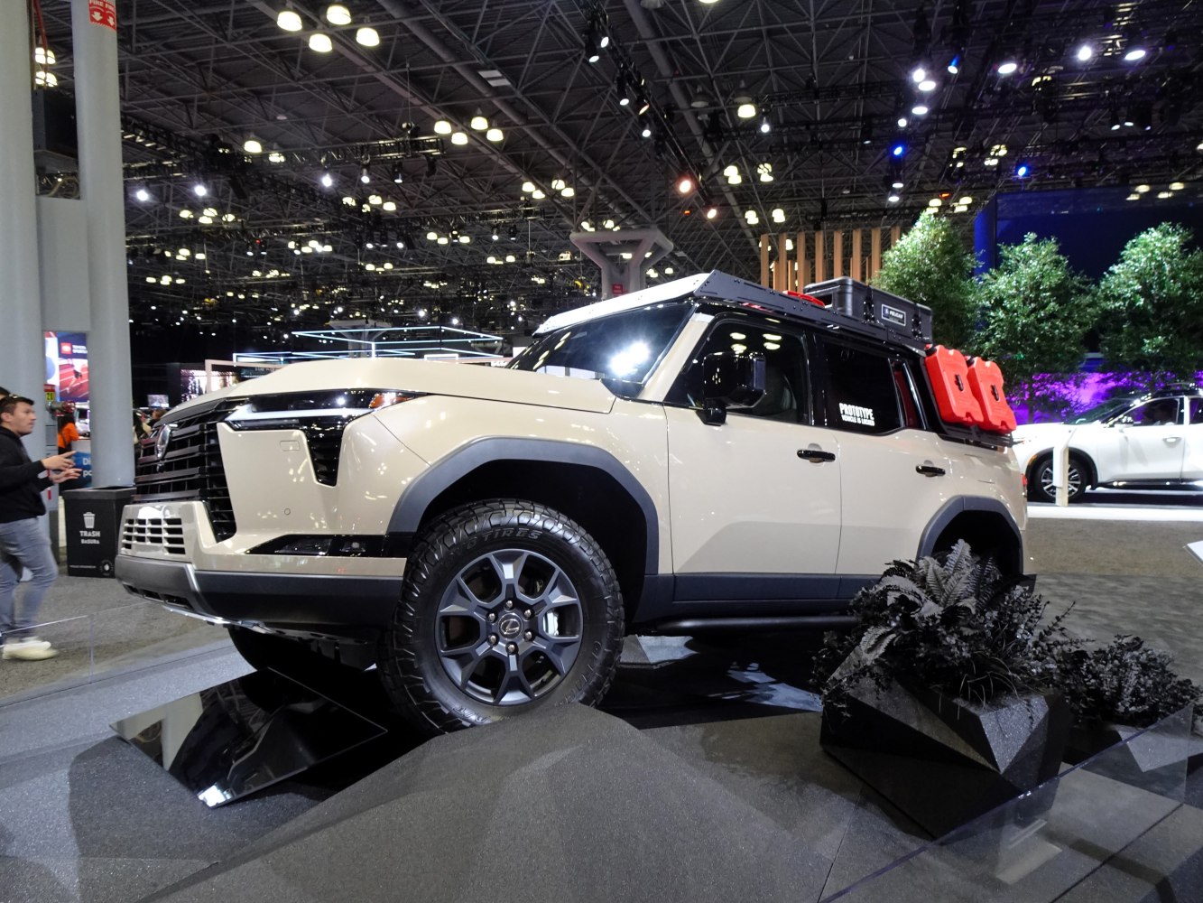 Off-road SUV with rugged tires, roof storage, and mounted fuel containers