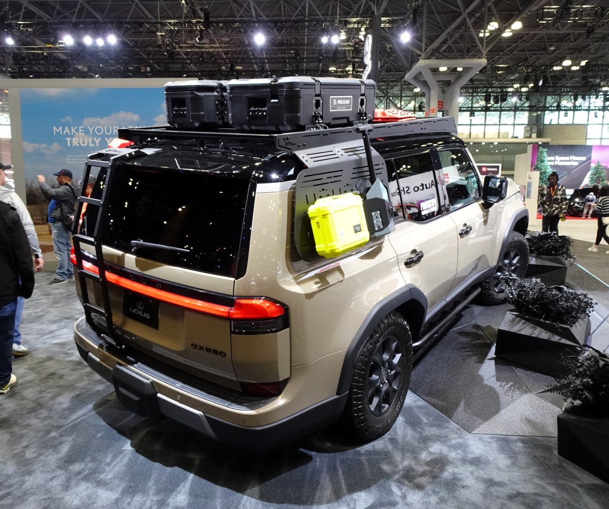 Rear view of SUV with roof rack, storage boxes, and off-road gear