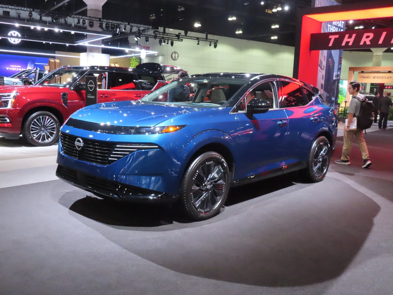 Sleek blue crossover SUV with LED headlights and aerodynamic design.