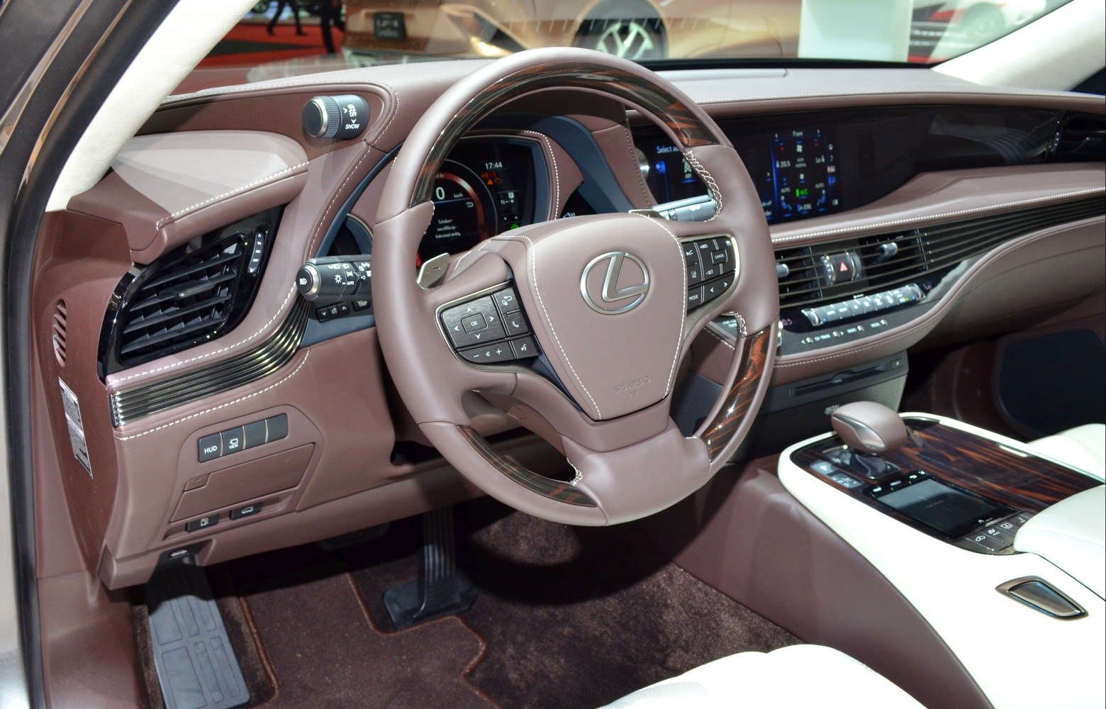 Brown leather steering wheel and luxurious dashboard with advanced controls