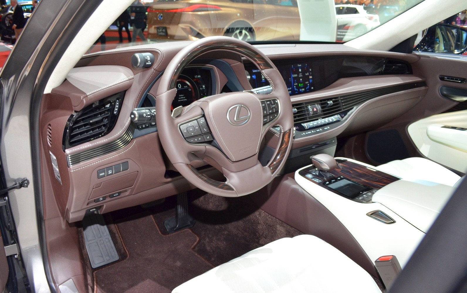Luxury car interior with brown leather steering wheel and digital dashboard