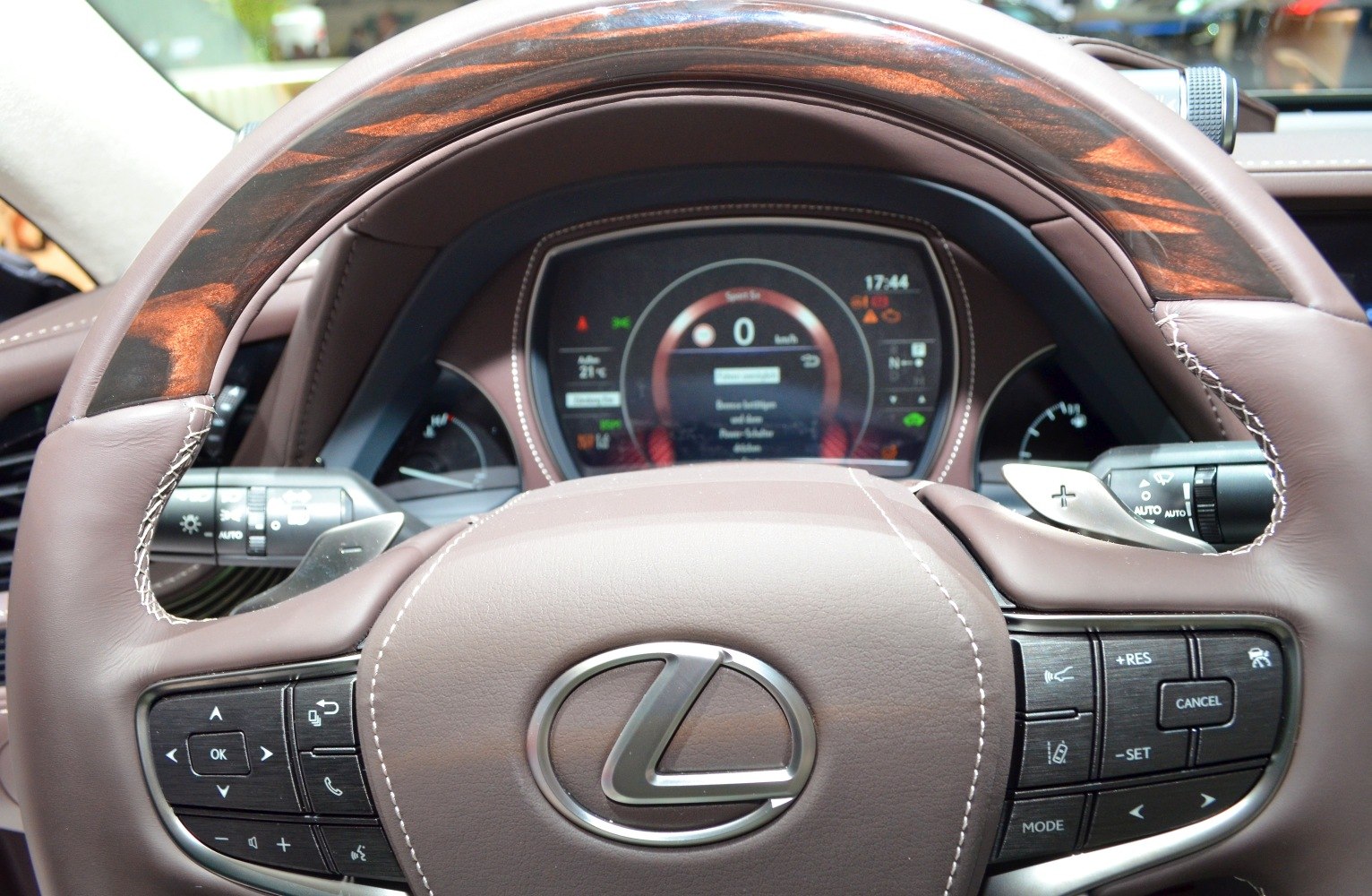 Close-up of steering wheel with controls and digital dashboard display