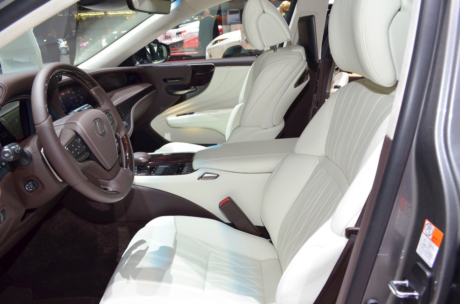 Luxury car interior with white leather seats and wood trim