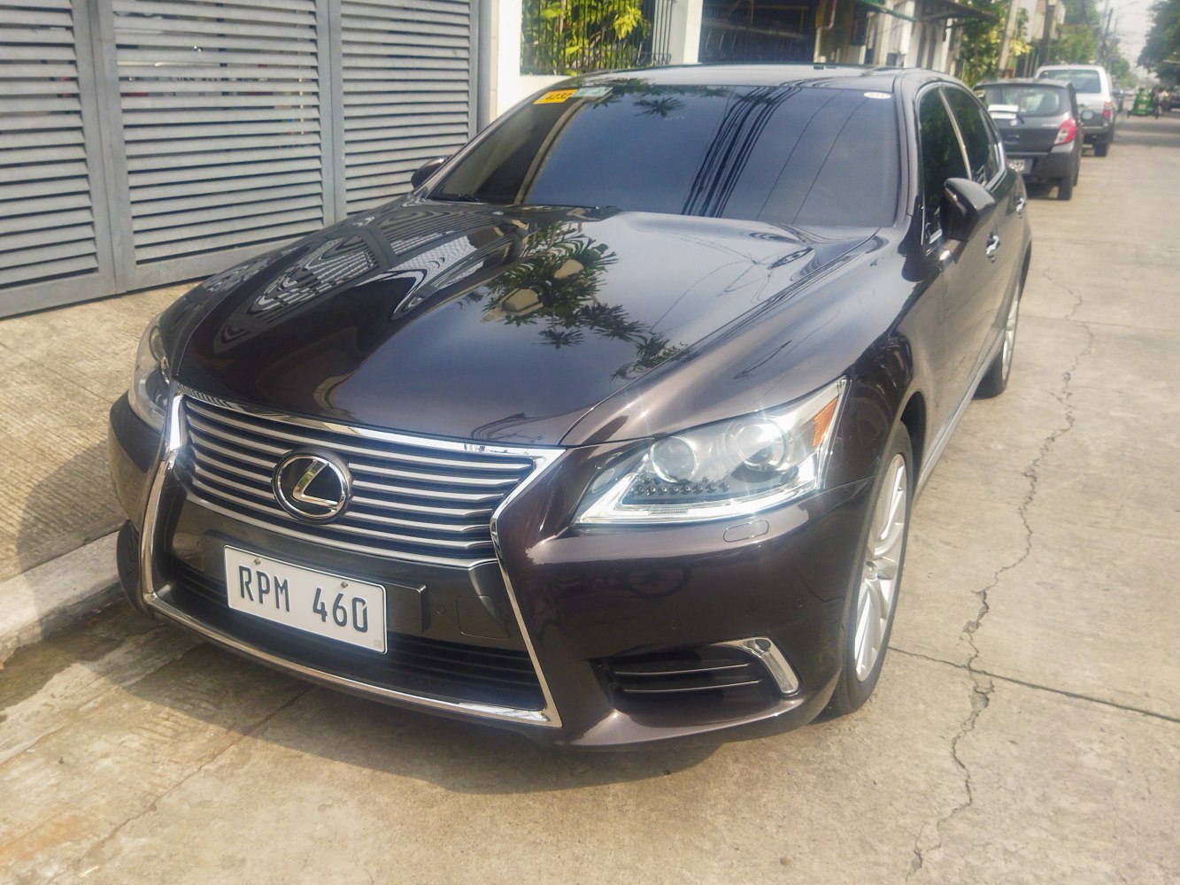 Front angled view of a luxury sedan with chrome grille and sleek headlights