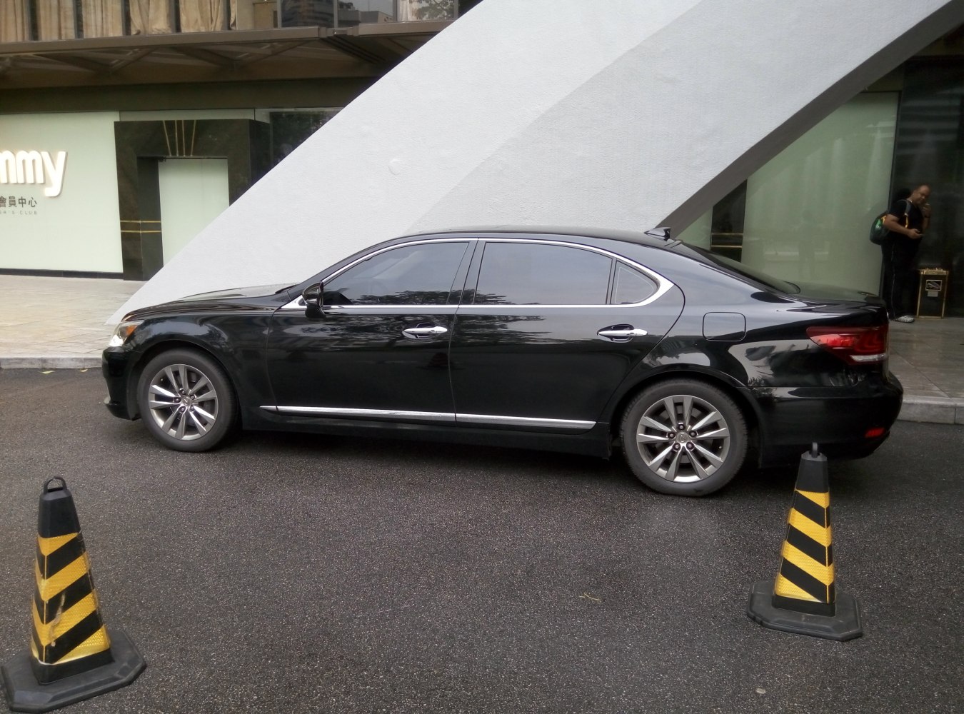 Side profile of a black luxury sedan with chrome trim and alloy wheels