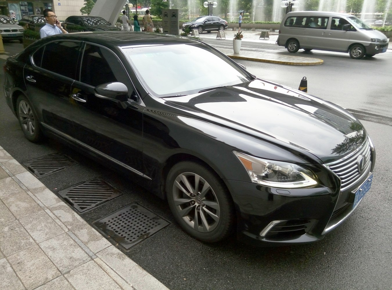 Front-side view of luxury sedan with sleek design and signature grille