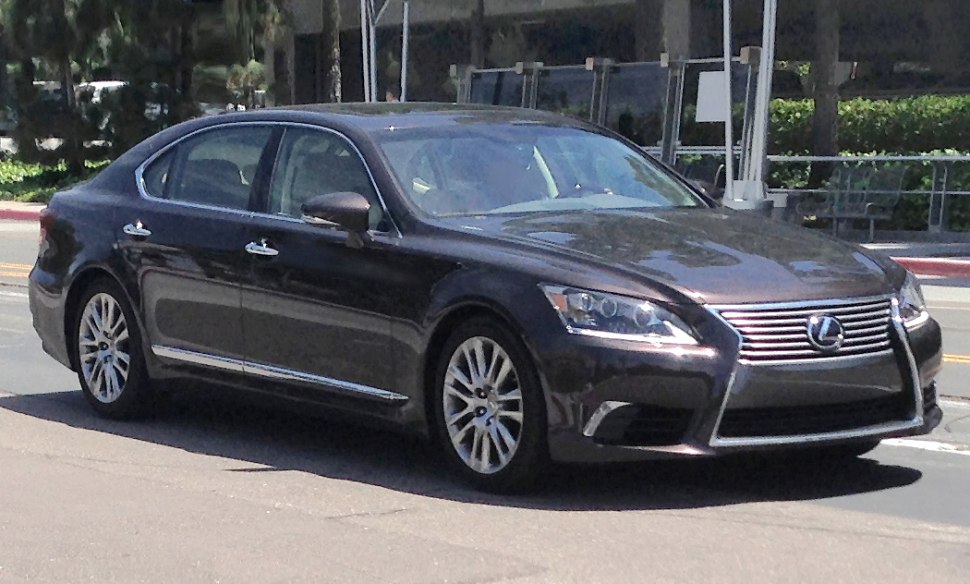 Front-side view of luxury sedan with distinct grille and headlights.