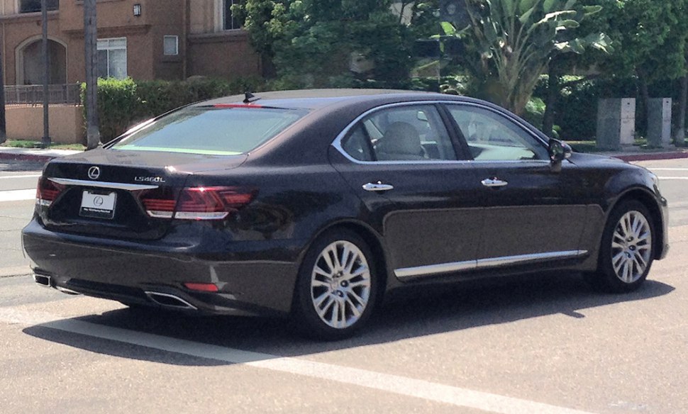 Rear and side view of luxury sedan with distinctive tail lights, alloy wheels, and chrome trim